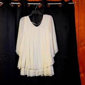 Cream colored nice blouse. Only worn once. No stains or holes.